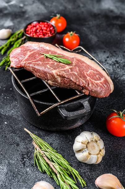 Raw picanha or Top Sirloin Cap steak on a grill. Black background. Top view. - Photo, Image