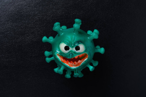 modello coronavirus con grande bocca e denti rossi su sfondo scuro - Foto, immagini
