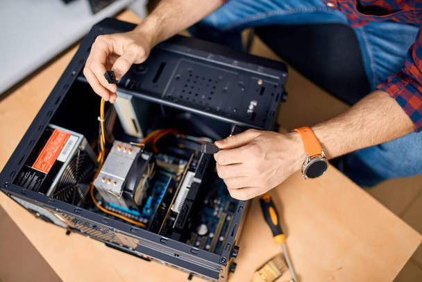 IT specialist repairing a computer - Photo, image