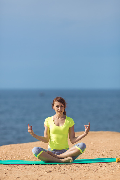 Woman yoga. Series. Outdoor. On the seashore - Foto, Imagen