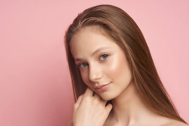 Beauty makeup. Portrait of a young girl with natural make-up on a pink background - Foto, immagini