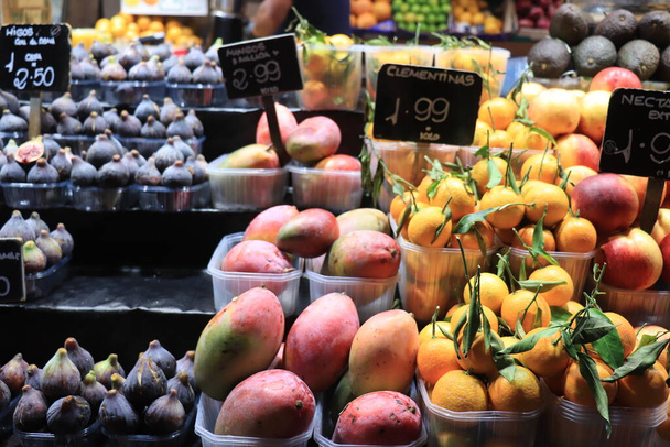 Different sorts of fruits on a Spanish market. Spanish text on tags: product names and prices - Fotó, kép