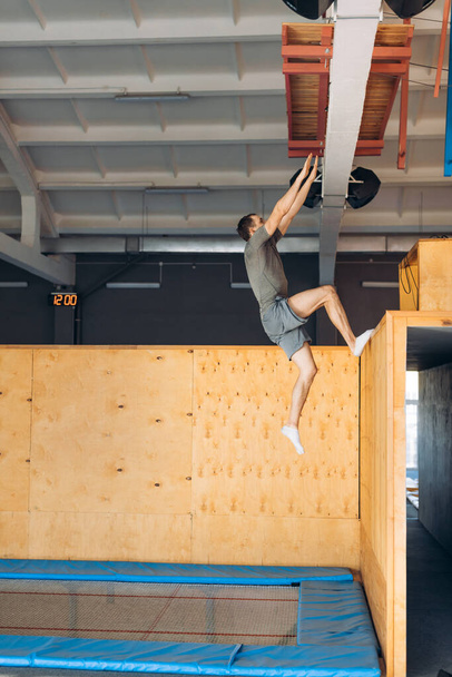 strong motivated athlete climbing to the wall - Photo, image