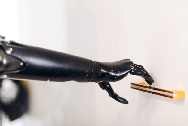 prosthetic black arm holding a handle - Foto, immagini