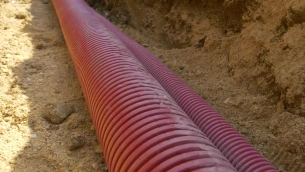 CLOSE UP: Detailed shot of corrugated plastic telecommunication tubing in ditch - Footage, Video