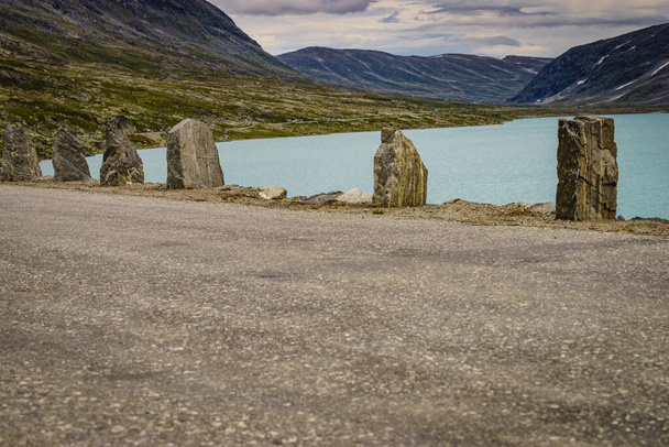 Mountains landscape and old road with long rows of guard stones on national tourist scenic route Gamle Strynefjellsvegen, Southern Norway. Travel and adventure. - Photo, image