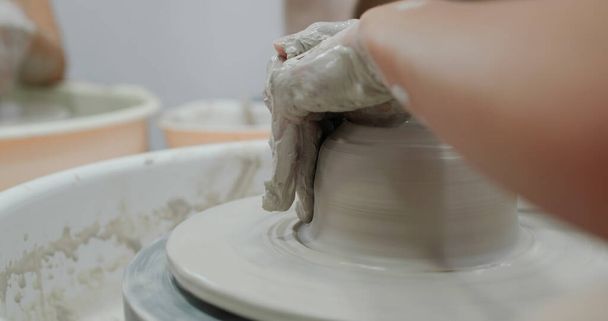 Hand work on pottery wheel, shaping a clay pot - Photo, Image