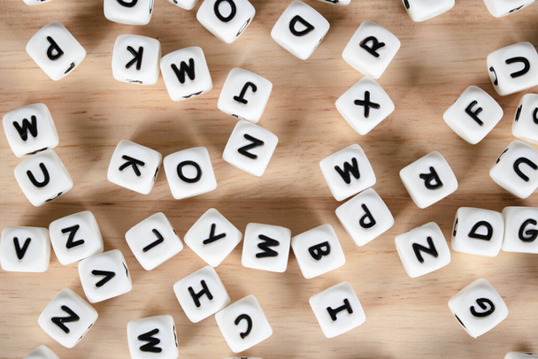 Text dice cube concept / Letter dices alphabet on wooden background. Block of alphabet studded on the floor. - Photo, Image