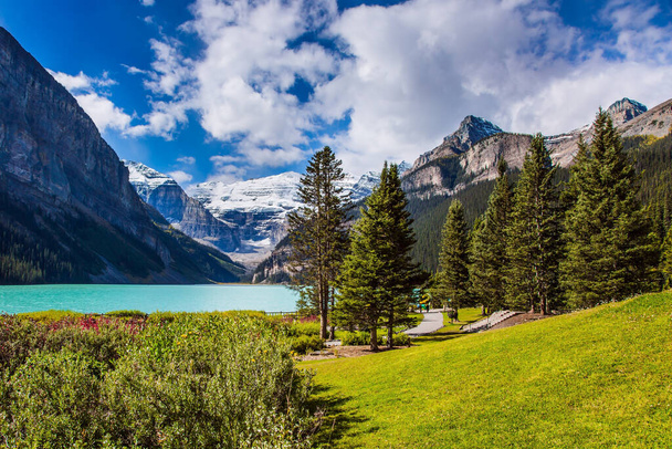  Glacial Lake Louise. Travel to the Rocky Mountains of Canada. The lake with azure water is surrounded by mountains and forests. The concept of ecological, active and photo tourism - Photo, image