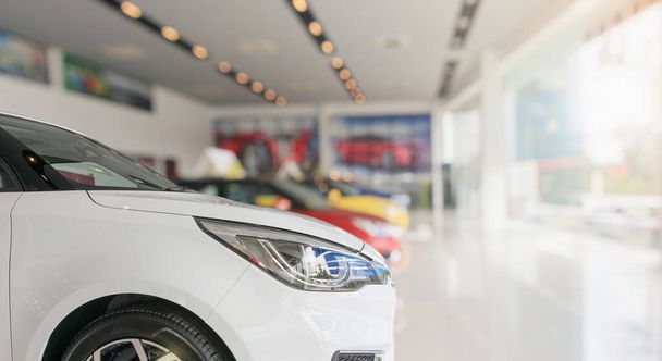 Close up front of new car in showroom background - Фото, изображение