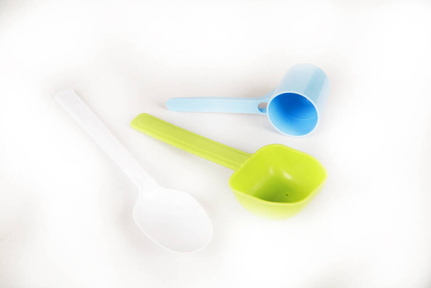 close-up view of colorful plastic spoons on white background - Foto, Imagen