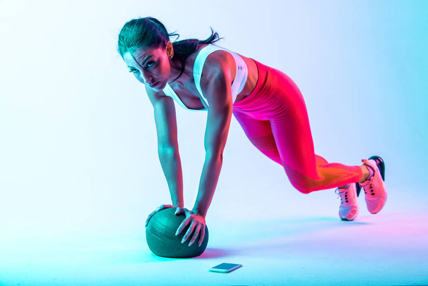Woman training with the exercizes ball in the gym - 写真・画像