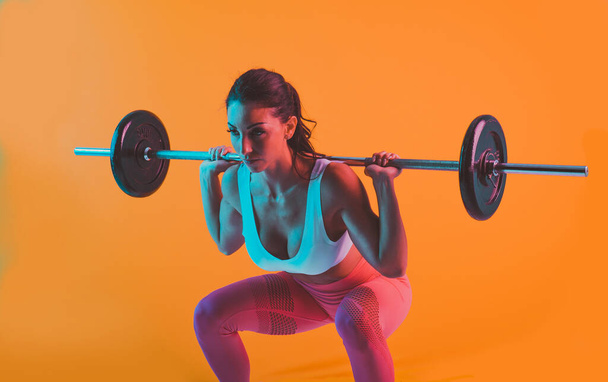 Woman training with barbells in the gym - Фото, зображення