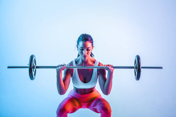 Woman training with barbells in the gym - Zdjęcie, obraz