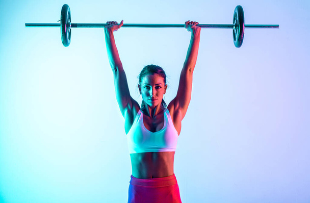 Woman training with barbells in the gym - Φωτογραφία, εικόνα