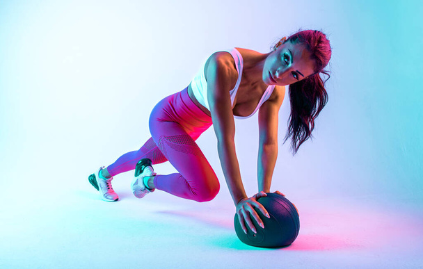 Woman training with the exercizes ball in the gym - 写真・画像