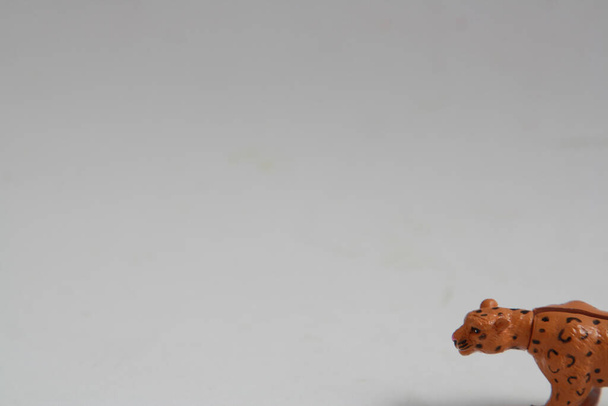 A small leopard plastic toy on a white background - Foto, imagen