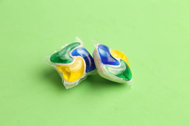 Two washing tablets on green background - Foto, immagini