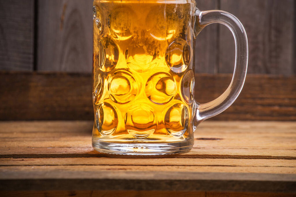 A glass of beer on a wooden surface - Φωτογραφία, εικόνα