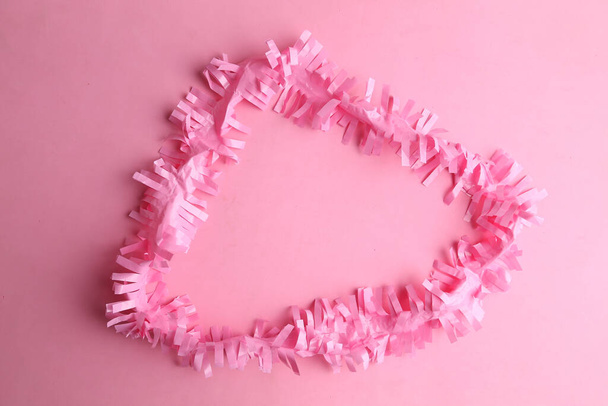 A closeup shot of a pink party ribbon on a pink background - Foto, immagini