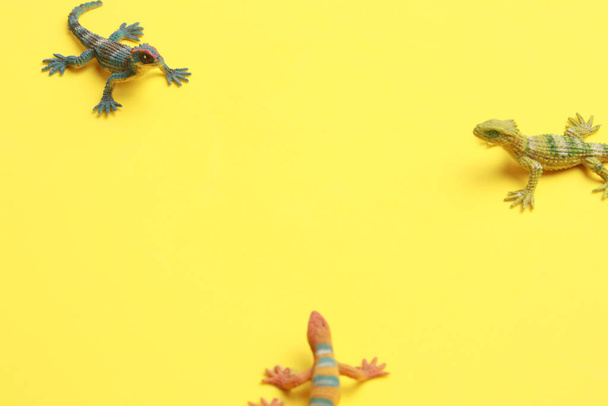 A closeup shot of lizard shaped rubber toy in color background - Fotó, kép