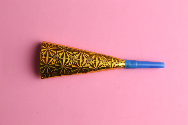 A party cardboard trumpet on colorful background - Photo, Image