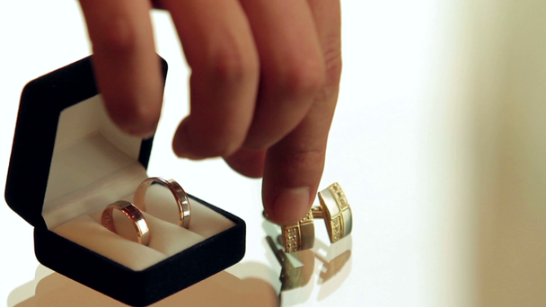Rings in the box and cufflinks are on a glass table - Footage, Video