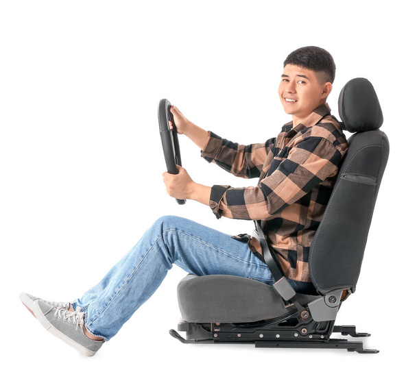 Asian man with steering wheel sitting on car seat against white background - Photo, Image