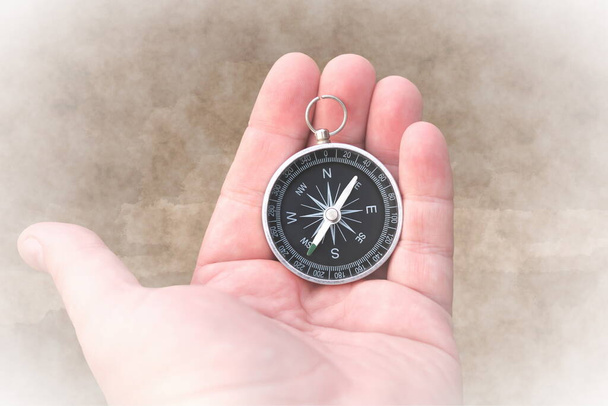 Abstraktní obraz s kompasem v ruce na abstraktním pozadí jako symbol cestovního ruchu s kompasem, cestování s kompasem a outdoorových aktivit s kompasem - Fotografie, Obrázek