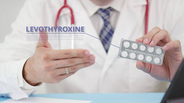 Levothyroxine generic drug blister pack with tablets in doctors hand - 写真・画像