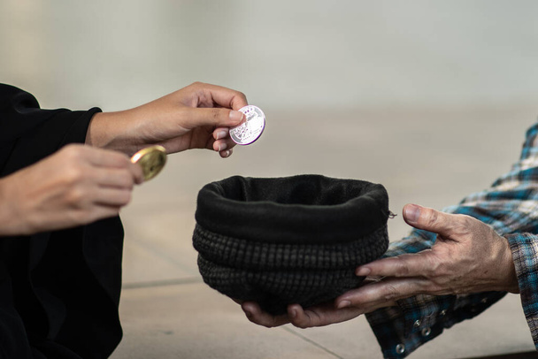 Обрізана рука дає монету для жебрака
 - Фото, зображення