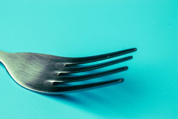 Metal fork close-up on blue background. Food service concept. - Foto, Imagem
