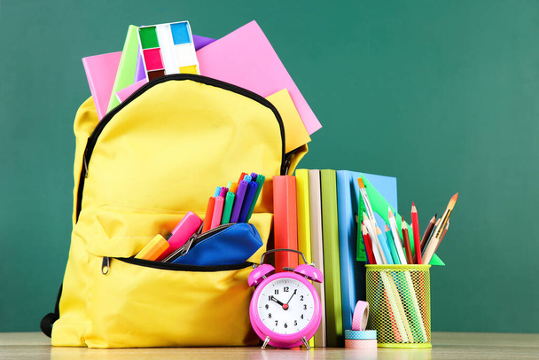 Backpack with school supplies on chalkboard background - Fotografie, Obrázek