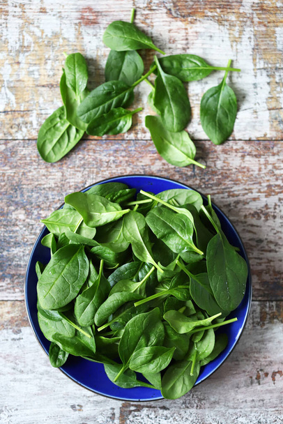 Fresh baby spinach on a plate. Juicy spinach leaves. Diet concept. Vegan food. - Photo, Image