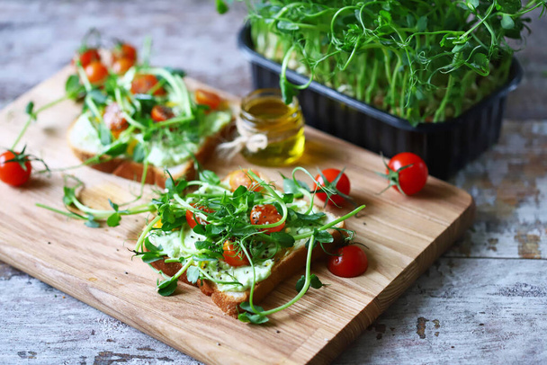 CBD food concept. The inscription CBD oil and toasts with microgreens. Food supplemented with cannabis oil. Healthly food. - Foto, Imagen
