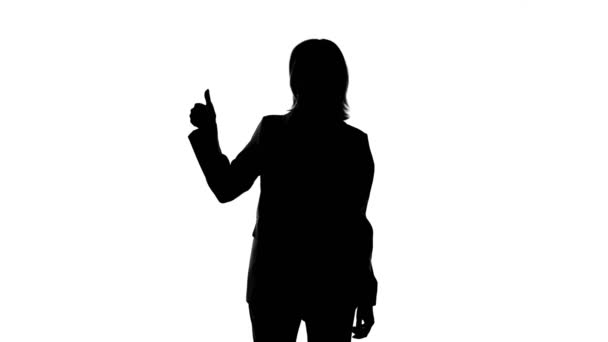 Video of womans silhouette in suit jacket with thumb gesture - Footage, Video