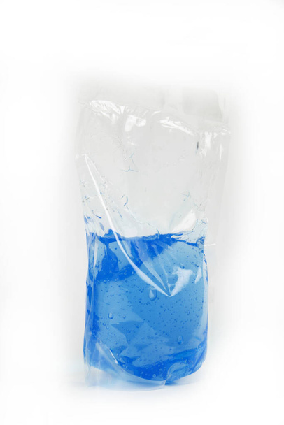 plastic bag with colored liquid on white background - Photo, image
