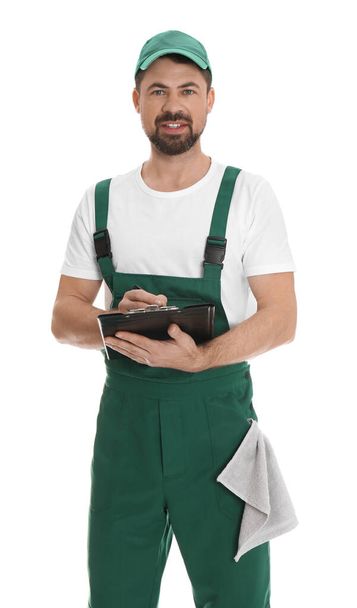 Portrait of professional auto mechanic with clipboard and rag on white background - Fotografie, Obrázek