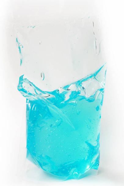 plastic bag with colored liquid on white background - Foto, Imagem