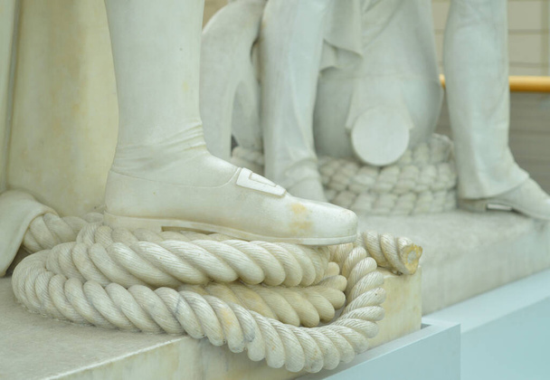 una statua che mostra un uomo con il piede sulla corda - Foto, immagini
