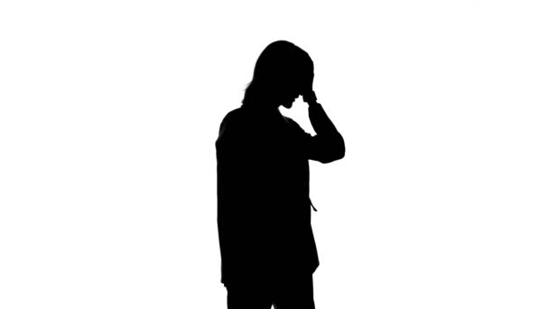 Shooting of womans silhouette in suit jacket with facepalm gesture - Footage, Video