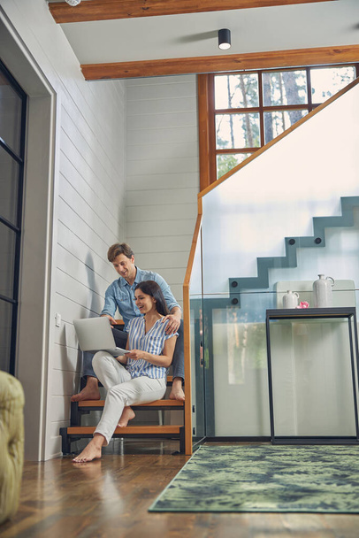 Romanttinen pari etsii näytön modernin kannettavan kotona - Valokuva, kuva