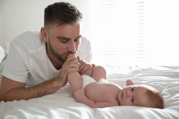 Father with his newborn son at home - Фото, зображення