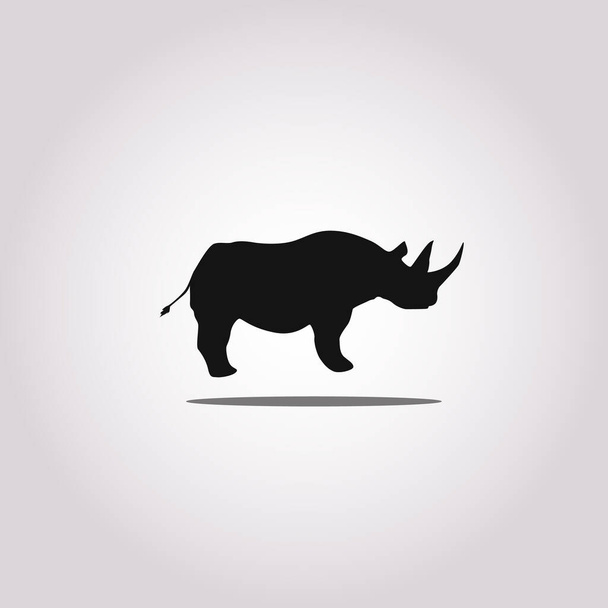 Vektorillustration einer Silhouette eines Nashorns, das auf isoliertem weißem Hintergrund steht. Rhinozeros Seitenansicht Profil. - Vektor, Bild