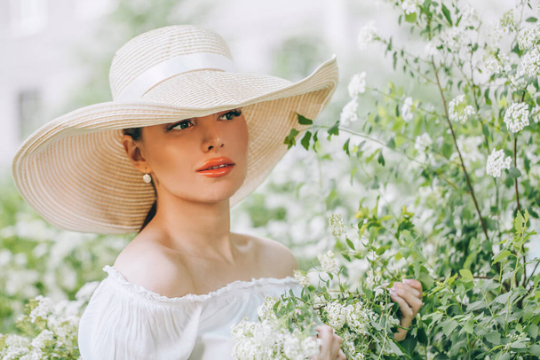 Cute woman fashion model with flowers outdoors - Fotó, kép