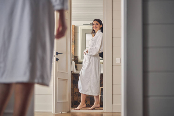Nainen yllään viihtyisä kylpytakki kun paikallistamiseen asunnossa - Valokuva, kuva