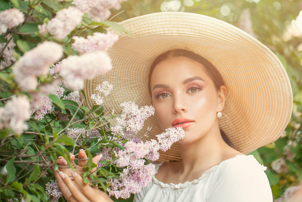 Pretty beautiful woman with flowers outdoors - Photo, Image