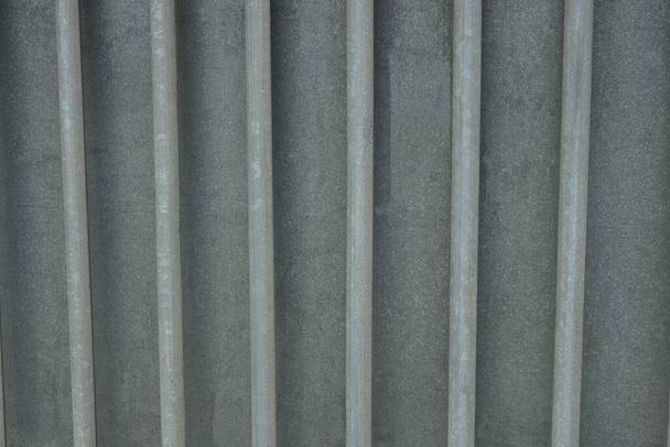 gray metal texture of iron wall with a row of rods - 写真・画像