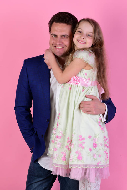 Girl and man with happy smiling faces on pink background - Foto, imagen