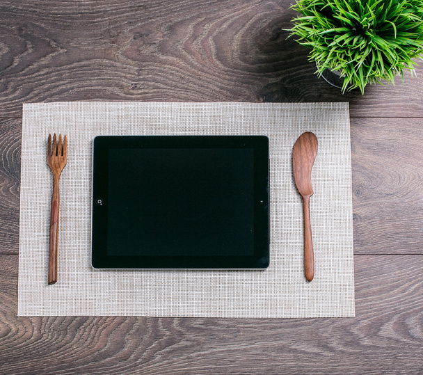 Tablet computer as a meal on the table - Photo, Image